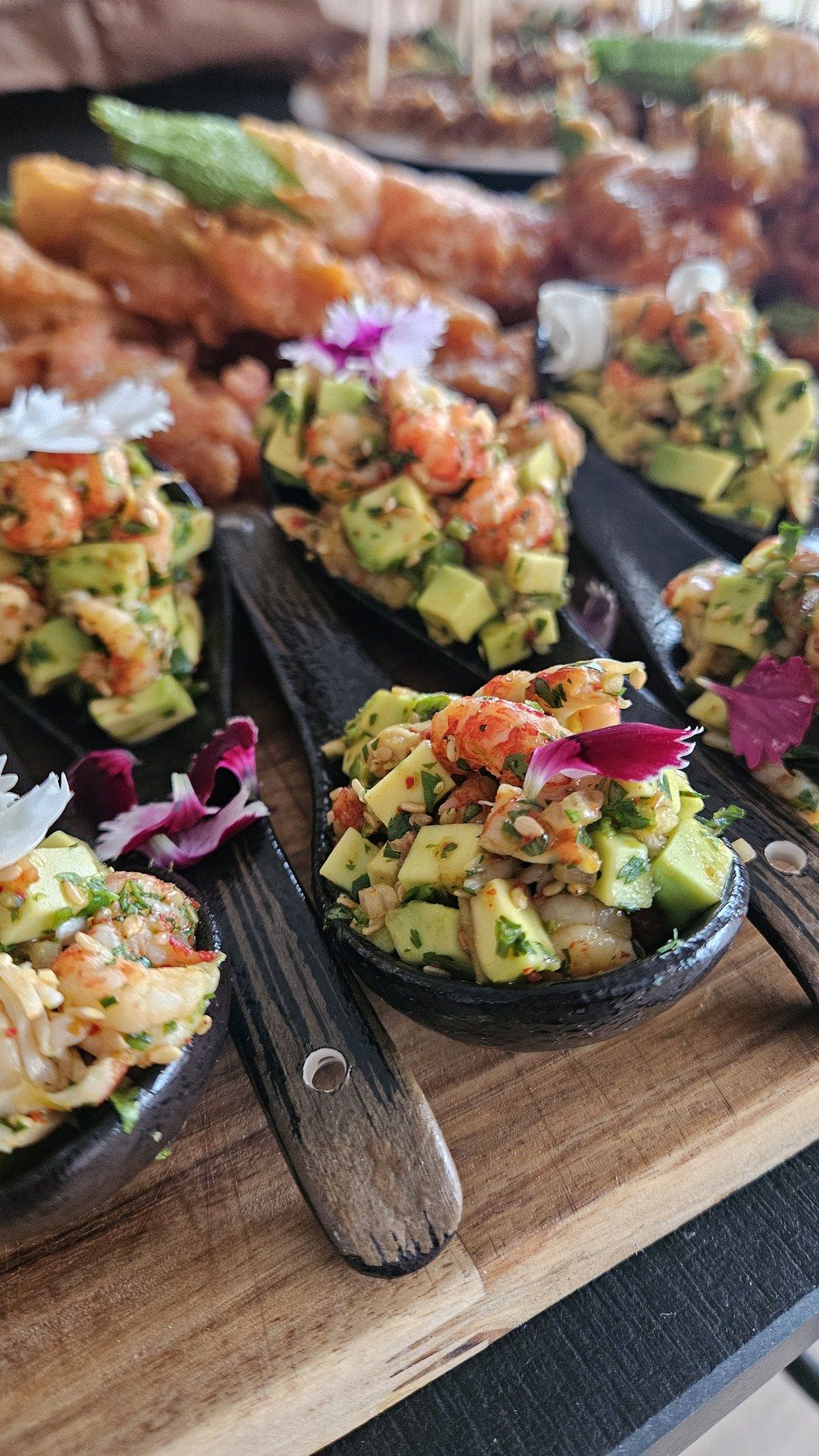 Avocado and prawn bites served on tasting spoons.
