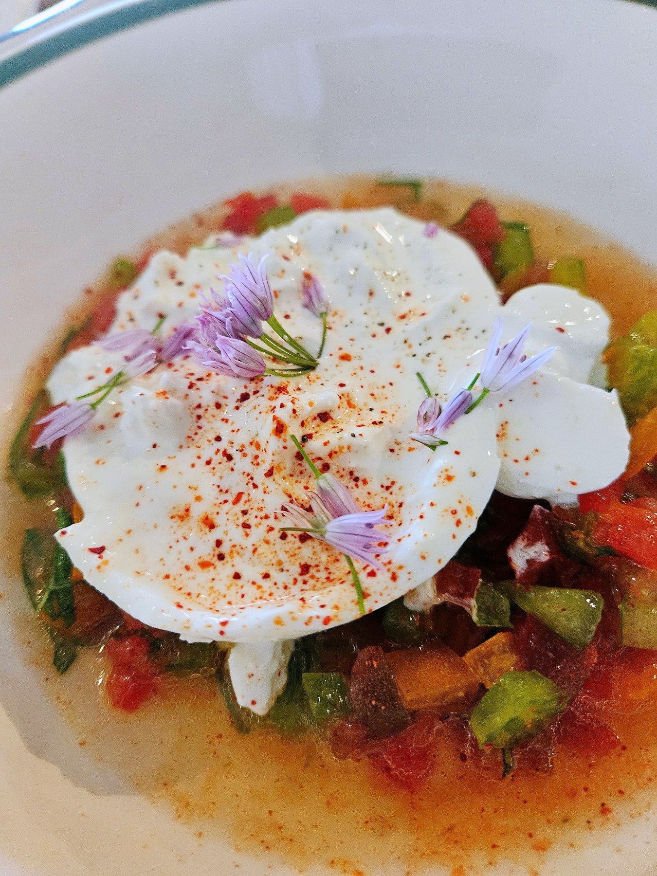 Small-portion risotto finished with edible flowers.