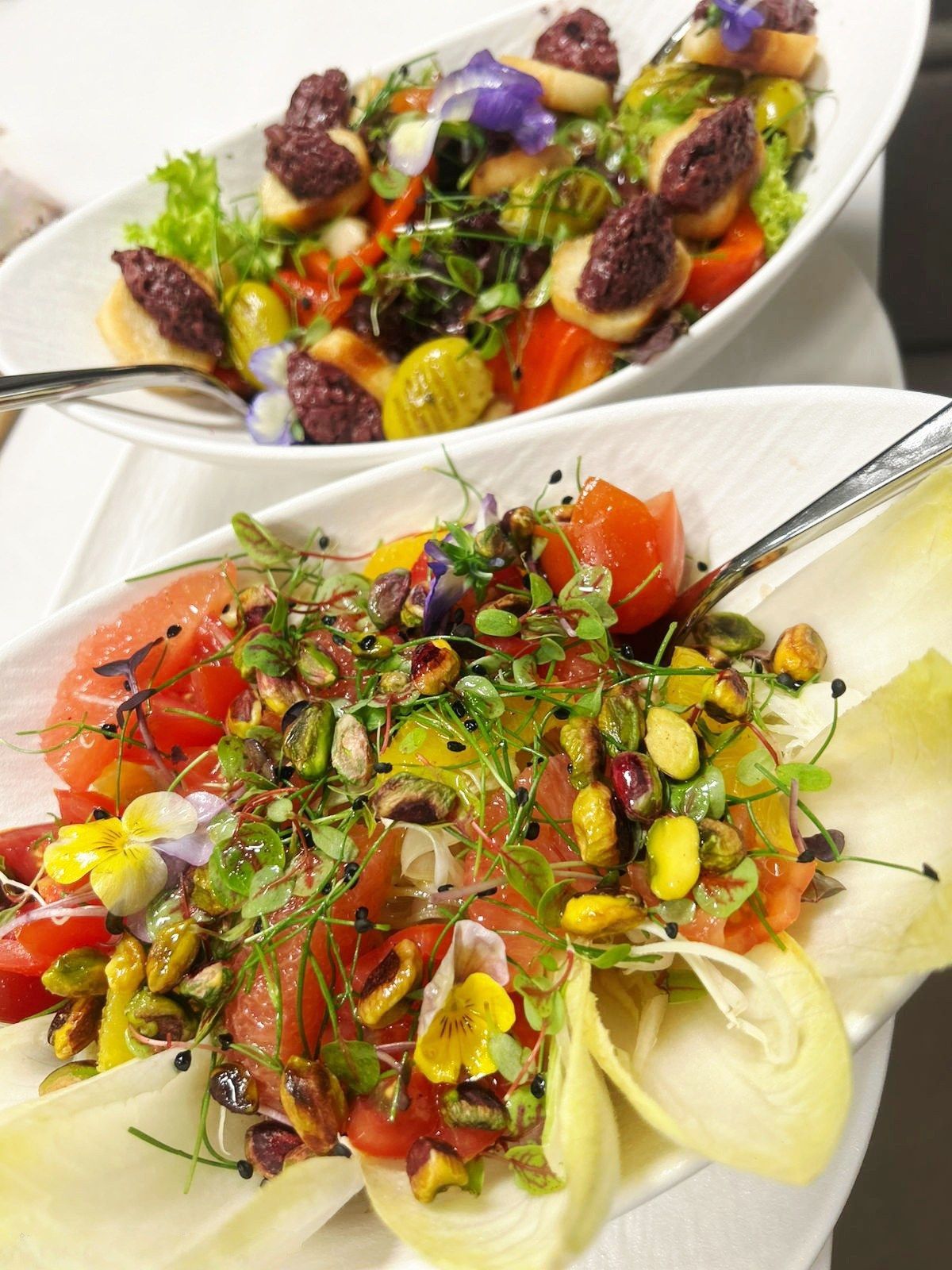 Composed endive salads dressed in serving bowls.