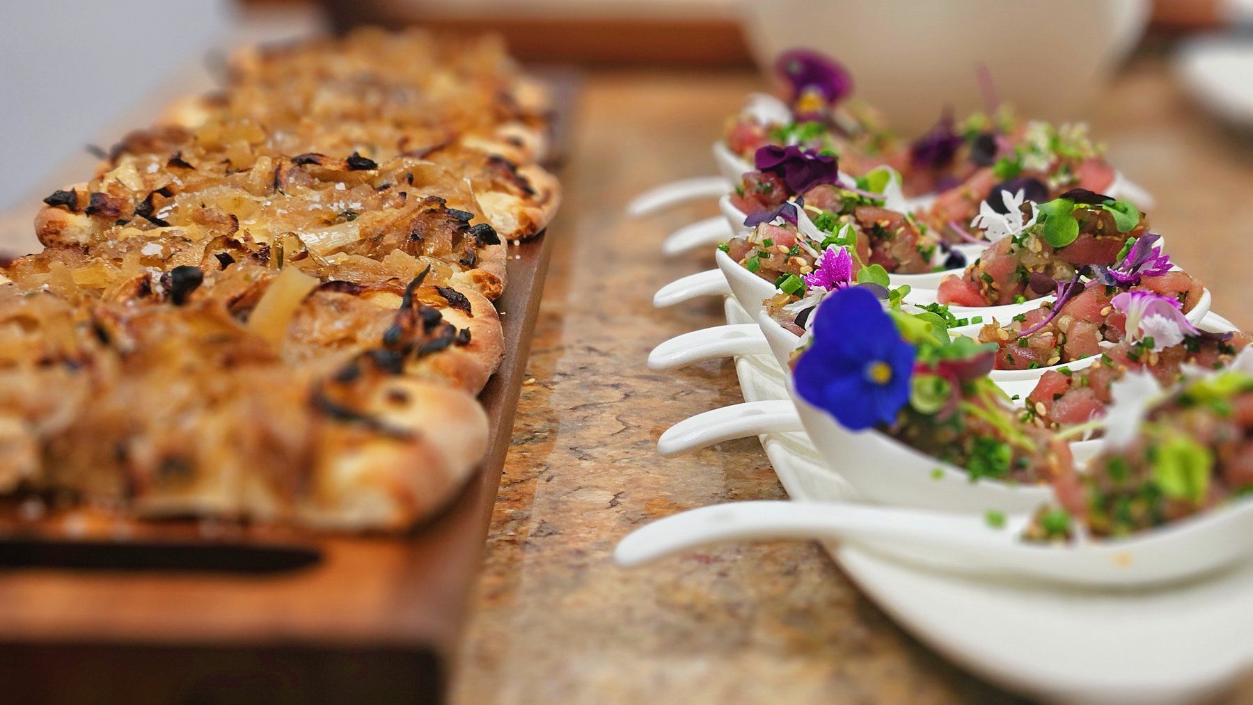 Pissaladière and tartare spoons plated for a private dinner.