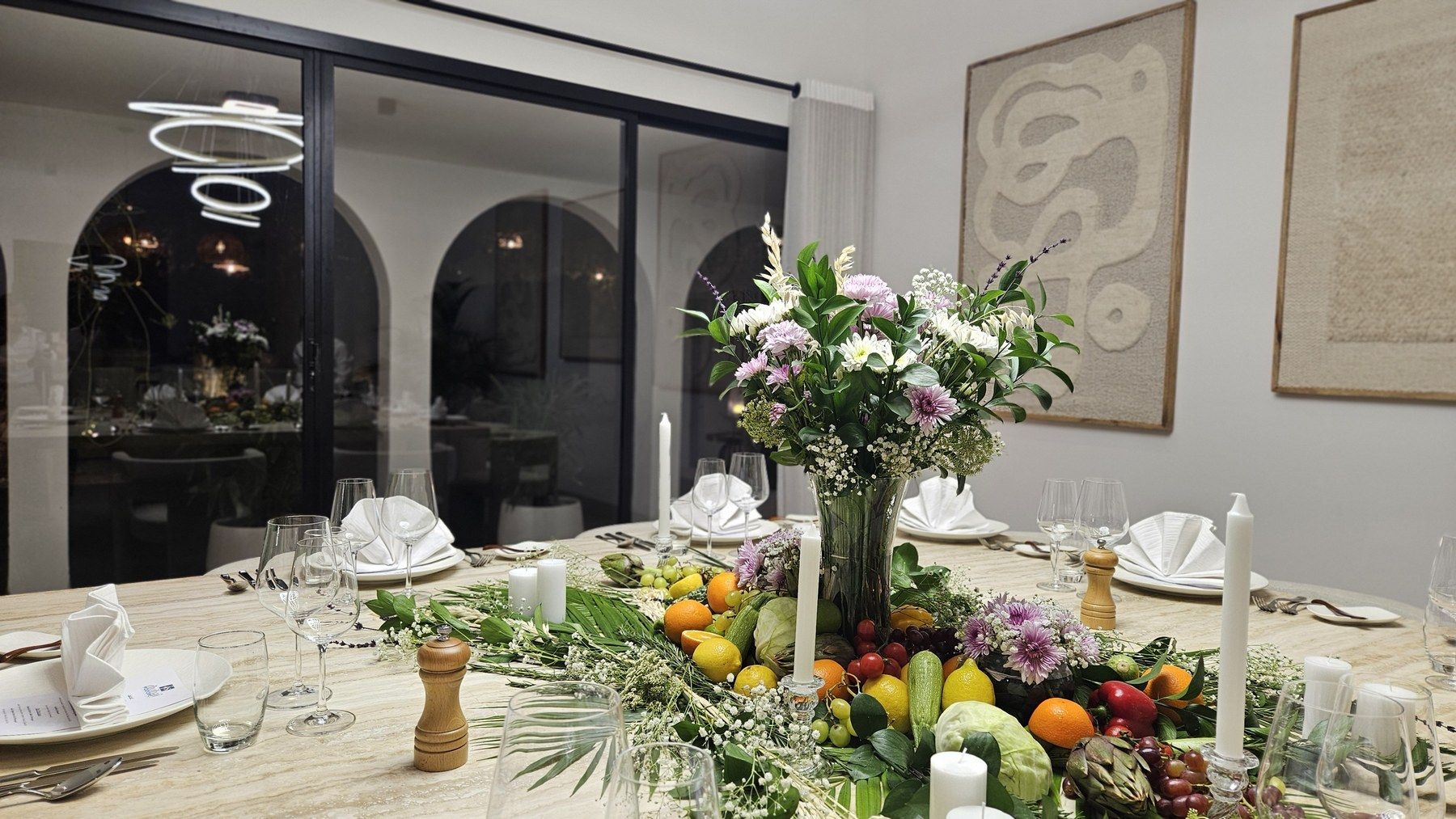 Marble table decorated with fruit, flowers and candles.