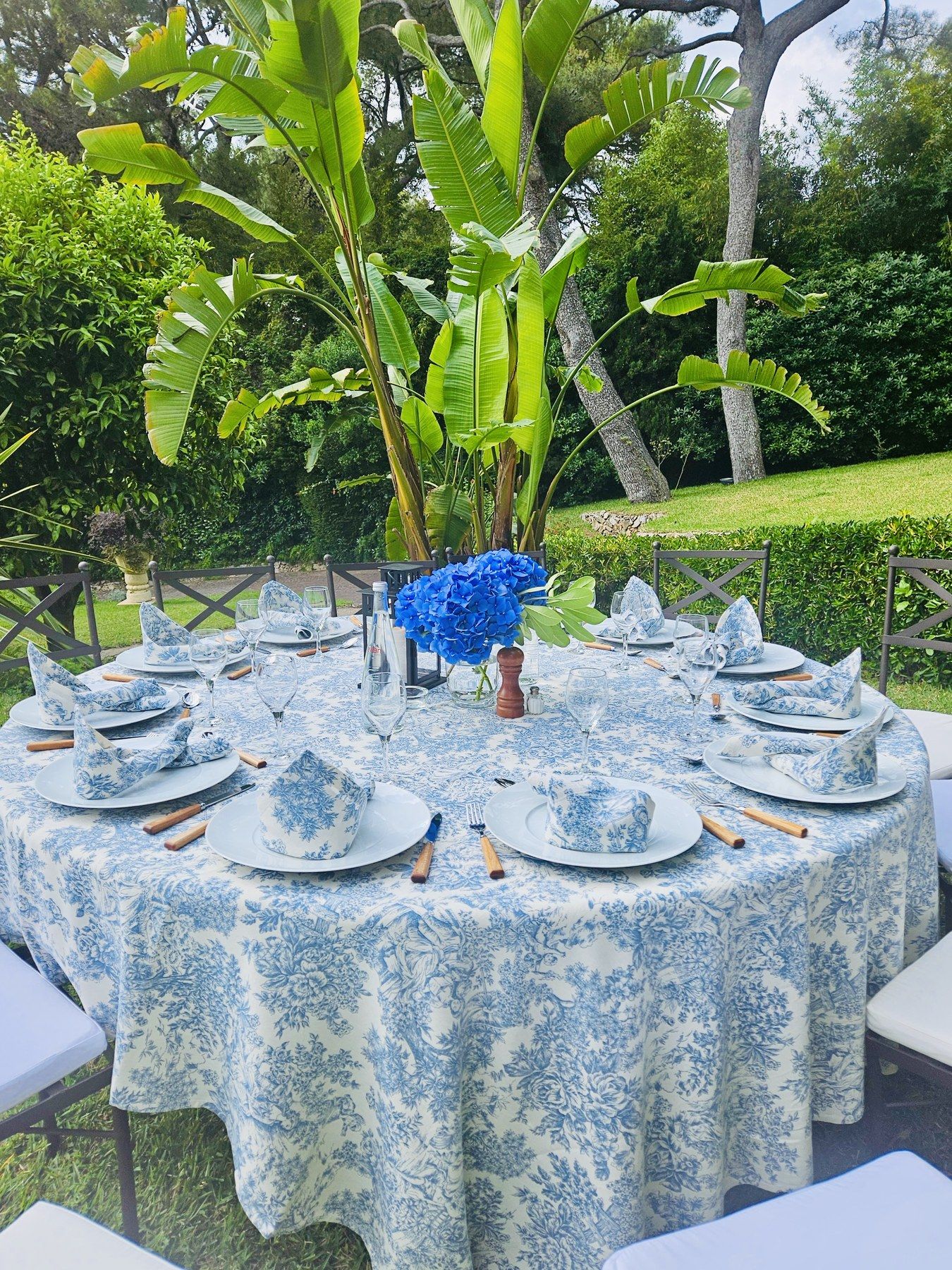 Blue toile de Jouy tablescape under the banana trees.