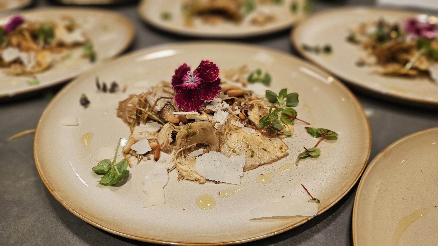 Fish carpaccio with shaved parmesan and edible flowers.